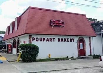 A bakery building with a distinctive red roof and signage that reads "Poupart Bakery."