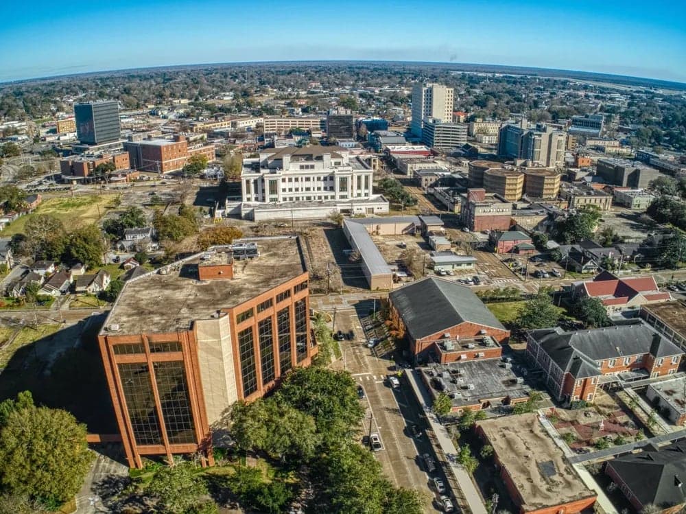 Aerial view of a cityscape featuring a mix of modern and historical buildings.